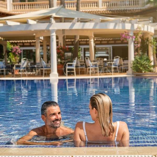 couple-resting-in-pool-of-resort-hotel.jpg